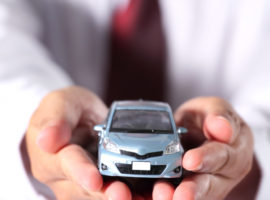 The blue car is in businessman hand