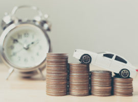 White miniature car on money coin stack growth with clock